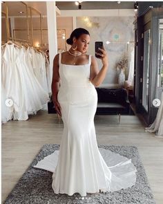 a woman taking a selfie in her wedding dress