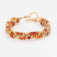 Free Shipping in the US This handmade bracelet features a beautiful blend of carnelian and glass beads. The beads are meticulously arranged in a staggered pattern, showcasing shades of rich red, warm amber, and soft gold. The bracelet is completed with a sturdy toggle clasp, adding security and elegance to the piece. Perfect for adding a touch of sophistication and vibrant color to any outfit. This bracelet is an exquisite example of craftsmanship and style. SPECIFICATIONS - 14K Gold Plated Togg Amber Carnelian Beaded Bracelets With Round Beads, Adjustable Amber Beaded Bracelets With Faceted Beads, Adjustable Carnelian Jewelry With Colorful Beads, Adjustable Czech Glass Beaded Bracelet With Polished Beads, Adjustable Carnelian Beaded Bracelets With Gemstone Beads, Adjustable Czech Glass Polished Beads Bracelet, Adjustable Carnelian Jewelry With Faceted Beads, Adjustable Amber Faceted Beaded Bracelets, Adjustable Carnelian Gemstone Beaded Bracelets