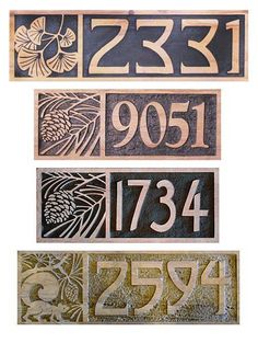 three wooden signs with numbers and symbols on them