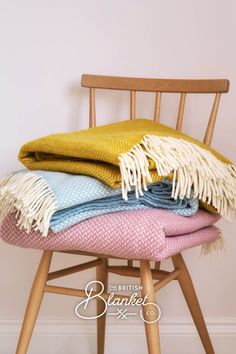 A wooden Ercol chair piled high with pastel coloured blankets Update Your Home, Warm Yellow, Spring Aesthetic, Signature Collection, Colorful Decor, Spring Decor, New Season, Pastel Colors, Pastel Pink