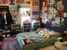 a bed room with a neatly made bed and lots of pictures on the wall