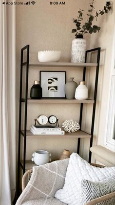 a living room filled with lots of furniture and decor on top of bookshelves