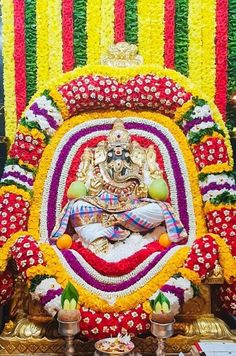 the statue is decorated with flowers and garlands