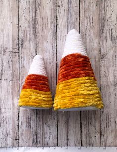 a pair of shoes that are sitting on top of a wooden floor with white and orange stripes