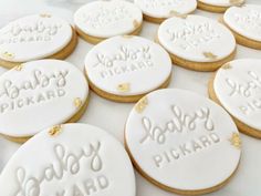 some cookies that are on a table with words written on them in white frosting