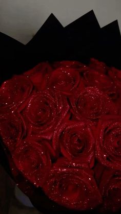 a bouquet of red roses sitting on top of a table