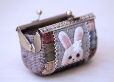 a small purse with an image of two rabbits on it