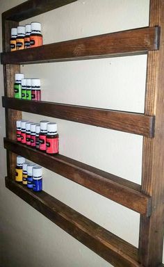 wooden shelves with various bottles on them in a wall mounted spice rack, made out of pallet wood