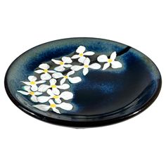 a blue plate with white flowers on it