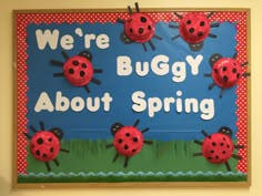 a bulletin board with ladybugs on it that says, we're buggy about spring