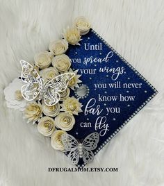 a graduation cap with flowers and butterflies on it that says until you spread your wings, you will never know how far you can fly