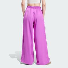 adidas Adicolor Satin Wide Leg Track Pants - Purple | Women's Lifestyle | adidas US Full Length Pants With Side Stripes, Adidas Three Stripes Pants, Casual Adidas Bottoms, Casual Workout Bottoms With Three Stripes, Athleisure Pants With Three Stripes For Loungewear, Athleisure Loungewear Pants With Three Stripes, Sporty Adidas Logo Pants, Sporty Adidas Spring Bottoms, Sporty Adidas Bottoms For Spring