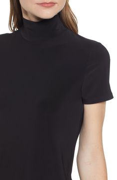 Strike a sleek and slimming silhouette in this mock-neck top with short sleeves for easy wear in any season. Mock neck Short sleeves 94% polyester, 6% elastane Machine wash, line dry Imported Point of View Classic Fitted Short Sleeve Top In Solid Color, Classic Black Tops, Classic High Stretch Black Top, Classic Fitted Elastane Tops, Sleek Black Mock Neck Top, Sleek Black Funnel Neck Tops, Chic Mock Neck Top With Short Sleeves For Work, High Stretch Mock Neck Top For Work, Sleek High Neck Top For Workwear