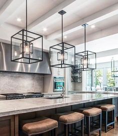 a large kitchen with an island and lots of stools