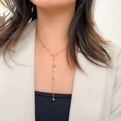 Coco Lariat Necklace is a dainty Y-shaped necklace with a flirtation of beads along the chain. This gorgeous necklace is stainless steel with gold plating, and it will not tarnish with minimal care. This chic, minimalist necklace will be something you wear daily! Gold Plating on Stainless Steel. Waterproof. LAST CHANCE = FINAL SALE Gold Y-shape Chain Necklace With Adjustable Chain, Gold Y-shape Adjustable Chain Necklace, Gold Y-shape Drop Necklace With Clavicle Chain, Gold Y-shape Drop Necklace With Delicate Chain, Gold Y-shape Dainty Drop Necklace, Drop Necklace With Satellite Chain As Gift, Dainty Gold Lariat Necklace With Satellite Chain, Adjustable Ball Chain Necklaces, Lariat Necklace With Beaded Chain For Gifts