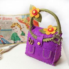 a small purple purse with flowers on it