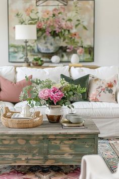 a living room filled with lots of furniture and flowers on top of a coffee table