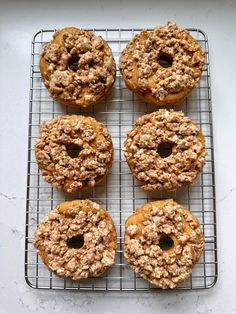 four doughnuts on a cooling rack ready to be eaten