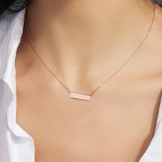 Immerse yourself in the timeless elegance of the Gold Bar Pendant Necklace from Jewellers District. Expertly handcrafted by our skilled artisans, this necklace is created entirely from recycled gold. Each link of the chain is meticulously polished to a mirror finish, creating a luminous glow that exudes luxury and sophistication. Pendant dimensions: 19 x 5 mm approx. Chain width: 1mm approx. Chain length: 16/18 inch. Chain type: Diamond-cut trace chain Closure: Lobster clasp Gold Bar Pendant Necklace, Gold Bar Pendant, Bar Pendant Necklace, Bar Pendant, Gold Bar, Recycled Gold, Bar Necklace, Three Stone, Diamond Cut