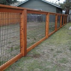 the fence is made of wood and has metal bars on each side, along with wire mesh