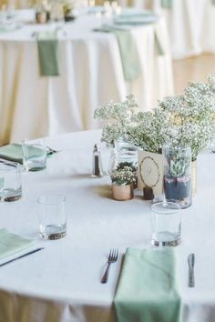 the table is set with flowers and place settings