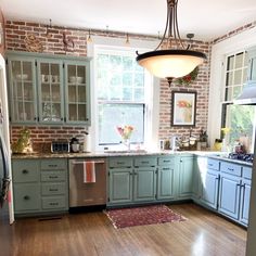 a kitchen with wooden floors and green cabinets