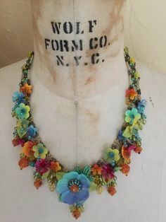 Dripping with colorful hand-painted flowers and glass beads, what a perfect necklace to make you feel like your on a holiday in Havana. This necklace has multi colored flowers of turquoise, yellow, orange and red. A unique and bright fun color combo.It measures almost 20 inches with a 4 inch extender so as you may adjust the length as needed. We use findings that are nickel free. This is a hand beaded piece of jewelry. All the work is hand sewn or wired without the use of glue. This heirloom qua Bohemian Multicolor Adjustable Flower Necklace, Adjustable Multicolor Flower Necklace With Flower Charm, Multicolor Bohemian Flower Necklace For Crafts, Multicolor Bohemian Flower Jewelry, Multicolor Bohemian Flower Necklace, Multicolor Bohemian Flower Necklace For Jewelry Making, Bohemian Multicolor Flower Necklace, Bohemian Multicolor Flower Necklace For Jewelry Making, Multicolor Bohemian Jewelry With Flower Design