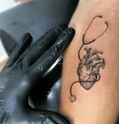 a tattoo on the arm of a woman with a stethoscope attached to it