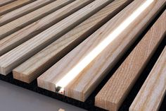 the wooden slats are lined up on the floor and ready to be used as furniture