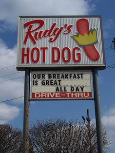 a sign for a hot dog restaurant on a pole