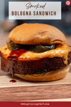 a grilled burger with cheese and pickles on it, sitting on a cutting board