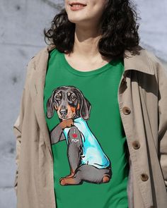 a woman wearing a green shirt with a dog on it