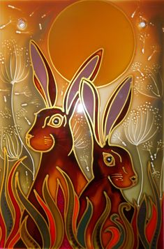 two rabbits are sitting in the grass with an orange sun behind them and some water droplets