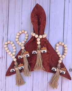 a brown bag with tassels and cars hanging from it's side on a white wooden surface