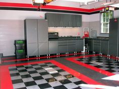 a large kitchen with checkered flooring and red trim on the walls is shown