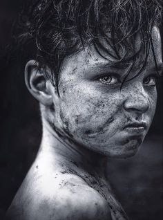 black and white photograph of a young boy with frecky hair on his face