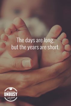 the days are long, but the years are short - mother holding baby's feet