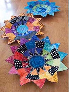 several colorful paper flowers on a wooden table