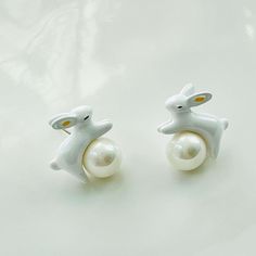 Hop into a whimsical world with our cute Enamel White Rabbit Pearl Stud Earrings. Our charming earrings feature a white bunny leaping over a pearl, making them the perfect accessory for those who love playful and adorable jewelry. This pair is inspired by both the charming nature of bunny and the timeless elegance of pearl. We have matching rabbit necklace, bracelet and ring available. The set will be packed with a box when you buy them. Weight: 5g per each Dimension: 1.8cm*1.9cm Materials: Enam Bunny Bracelet, Bunny Jewelry, Rabbit Necklace, Rabbit Jewelry, Rabbit Earrings, Easter Jewelry, White Bunny, White Rabbit, Pearl Stud Earrings