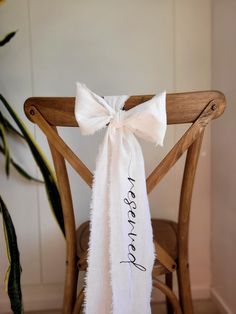 a chair with a white sash tied to it