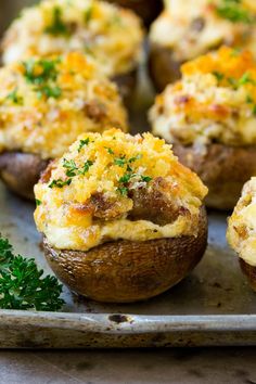 sausage stuffed mushrooms on a baking sheet with parsley