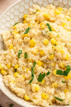 a bowl filled with mashed corn and garnished with parsley on top