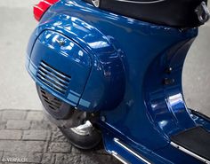 a blue scooter is parked on the street