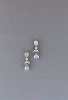 Our Gorgeous AURA Simulated Diamond Earrings with Amazing sparkle. The design features of tear drop and leaf shape crystals to make every look stand out. They are perfect for a simple but glamorous look. Handcrafted with the Highest Quality & Finest Materials & CZ Crystals Platinum plated - guards against scratches and tarnish. Approx. Length 1.0 in (2.54 cm) FREE Shipping in USA. Wedding Earrings Silver, Dazzling Silver Bridal Earrings For Formal, Elegant Silver Bridal Earrings With Sparkling Stones, Dazzling Cubic Zirconia Dangle Bridal Earrings, Dazzling Silver Dangle Bridal Earrings, Dazzling Silver Bridal Earrings With Sparkling Stones, Luxury Elegant Gold-tone Earrings, Simple Bridal Jewelry, Silver Earrings Wedding