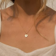 "Our tiny circle initial necklace is a fun choice when you want to make a simple, discreet statement of any single letter, number, or character that you feel defines you the best. Made of 14K gold-filled, the shiny finish disc comes on a dainty and delicate chain, giving you a truly minimalist look. Free Engraving for a limited time! NECKLACE DETAILS ⚬ 14k gold-filled disc(s) and chain. ⚬ Disc measures 10mm (.39\"). ⚬ Chain in your choice of 16\", 18\", or 20\" length ⚬ Personalized engraving of Circle Initial Necklace, Meaningful Necklaces For Girlfriends, Tiny Initial Necklace, Gold J Necklace, Minimalist Initial Pendant Charm Necklace With Birth Flower, Minimalist Birth Flower Charm Necklace With Initial Pendant, Minimalist Birth Flower Initial Pendant Charm Necklace, Minimalist Birth Flower Initial Pendant Necklace, Minimalist Jewelry With Birth Flower Initial Pendant