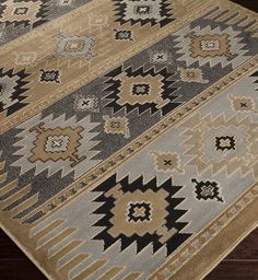 a brown and black rug on top of a wooden floor