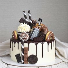 a birthday cake with chocolate and cookies on top