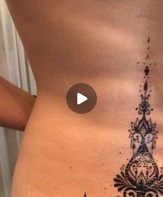 a woman's stomach with a tattoo on it