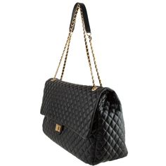 DETAIL Black and Gold Quilted Stitch Pattern Chain adjusts to one strap or two Soft Polyurethane Material Oversized Bag Travel Bag/Overnight Bag DESCRIPTION Oversized black quilted messenger bag with gold chain straps with pu material woven through the chains. This bag is excellent to use as a carry on bag, small duffle bag, and you can even use it as an overnight travel bag. The bag features a twist to lock metal closure on the fold over flap. The inside of the purse features several sectioned Classic Black Bag With Gold Chain, Small Duffle Bag, Overnight Travel Bag, Oversized Bag, Elegant Bags, Quilt Stitching, Black Quilt, Overnight Bag, Bag Travel