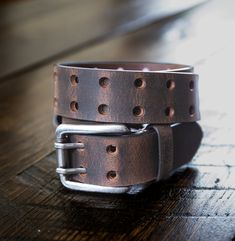 **FULL Grain Buffalo Leather 2-Hole Jeans Belt - Brown **Solid One Piece Buffalo Leather Belt Strap **Crazy Horse Finished Leather **Heavy 10-12 oz leather - 3.9mm to 4.25mm thick **Width is 1 1/2" or 38mm **Matching Buffalo Leather Belt Loop **Antique Nickel Finished Heavy Duty Roller Buckle Made from Zinc Alloy (Does not include Nickel - Nickel Free) **Two Parallel Rows of Punched Holes Run Length of the Strap BELT SIZING - What size do you buy? Option 1:  Most Accurate Way   Lay your current Adjustable Artisan Leather Belt Buckles, Adjustable Brown Bridle Leather Belt, Adjustable Brown Bridle Leather Belt Buckles, Rustic Distressed Brown Leather Belt Buckles, Adjustable Brown Rustic Belt Buckle, Rustic Adjustable Brown Belt Buckles, Adjustable Rustic Brown Belt Buckle, Rustic Distressed Brown Leather Belt Buckle, Adjustable Rustic Leather Belt